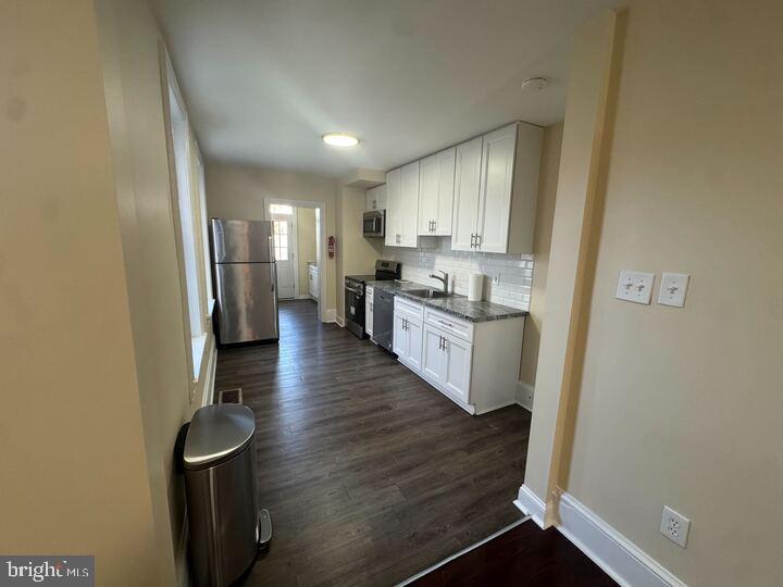 405 Walnut Street Royersford, PA 19468 - Photo 14 of 26 a kitchen with stainless steel appliances granite countertop a refrigerator a sink dishwasher and a stove with wooden floor