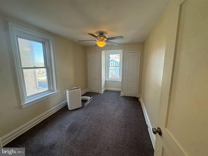 405 Walnut Street Royersford, PA 19468 - Photo 19 of 26 a view of an empty room with window and chandelier fan