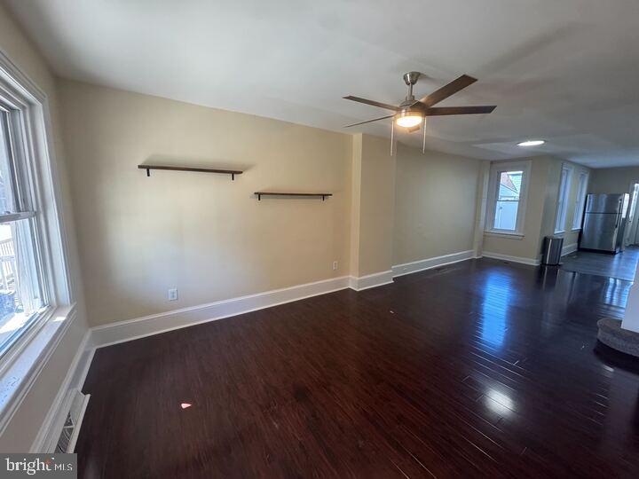 405 Walnut Street Royersford, PA 19468 - Photo 9 of 26 an empty room with wooden floor a ceiling fan and windows