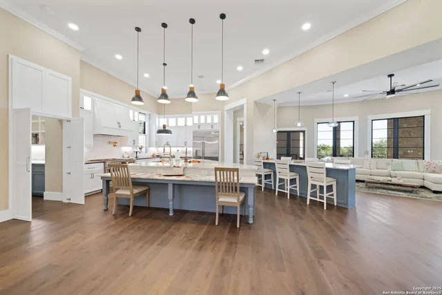 a large kitchen with a table and chairs in it