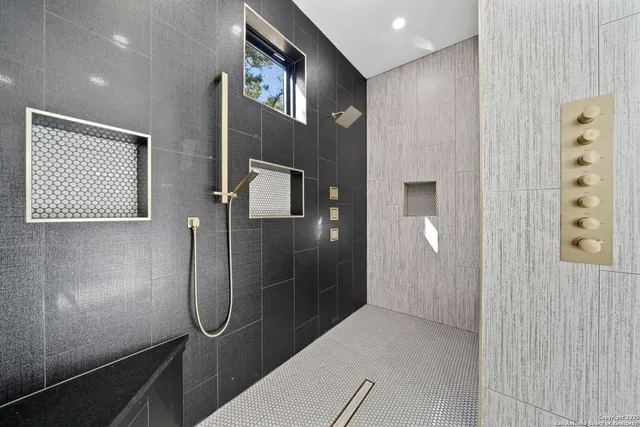 a bathroom with a glass shower door