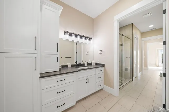 a bathroom with a double vanity sink mirror and