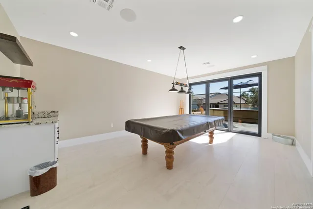 a living room with a table chairs and a window