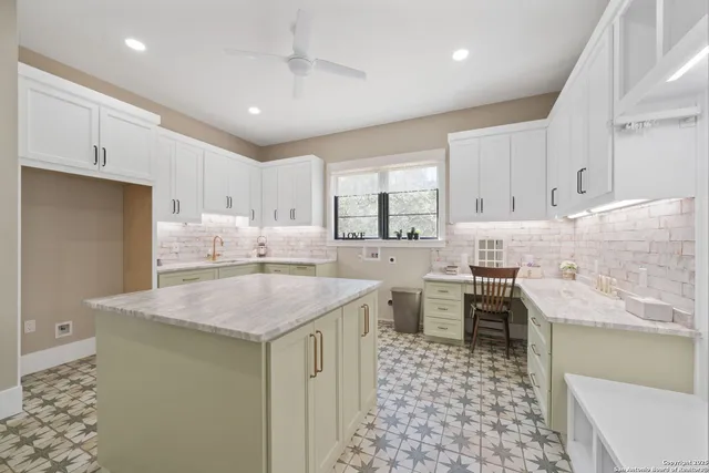 a kitchen with stainless steel appliances granite countertop a sink stove and cabinets