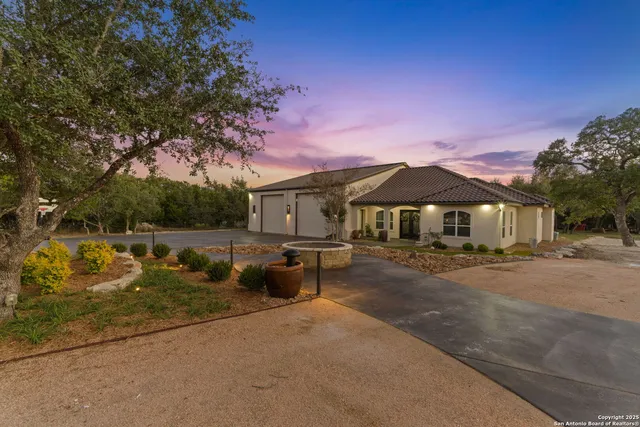 a view of a house with backyard and sitting area