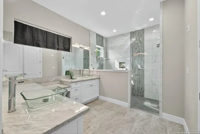 a bathroom with a tub sink and mirror