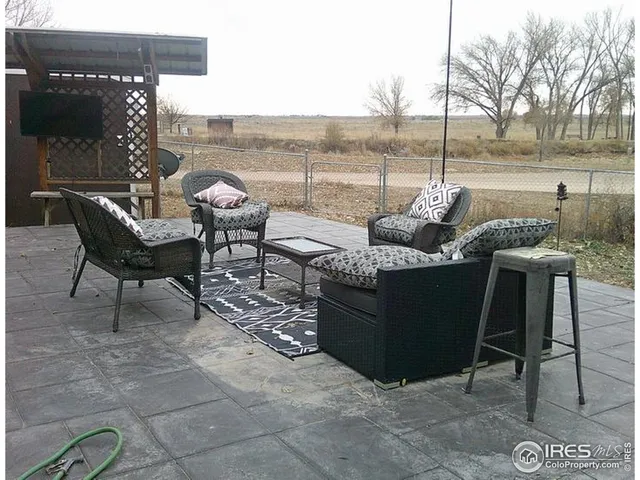 a view of a terrace with furniture and a lake view