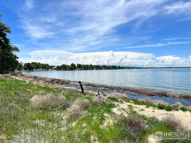 a view of a lake with houses in the back