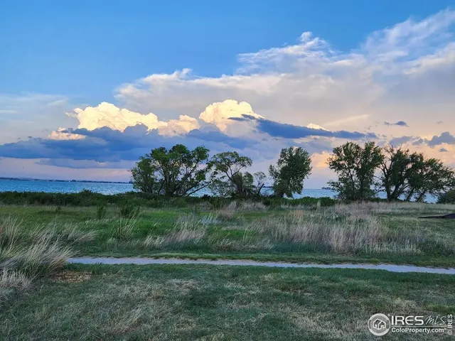 a view of a lake with a house in the background