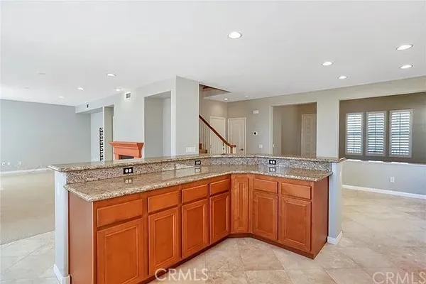 a bathroom with a granite countertop sink and a bathtub