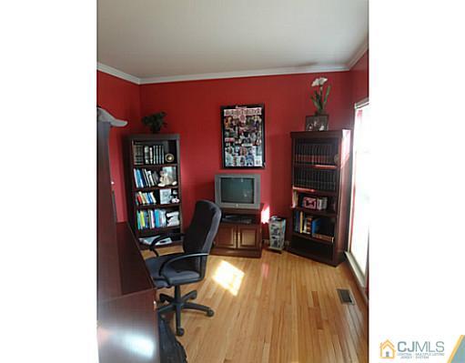 1 Sunflower Road Somerset, NJ 08873 - Photo 14 of 25 a workspace with furniture and wooden floor