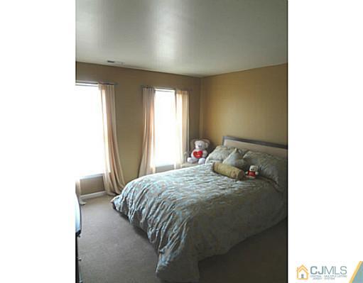 1 Sunflower Road Somerset, NJ 08873 - Photo 22 of 25 a bedroom with a bed and a window