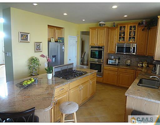 1 Sunflower Road Somerset, NJ 08873 - Photo 10 of 25 a kitchen with granite countertop a sink stainless steel appliances and cabinets
