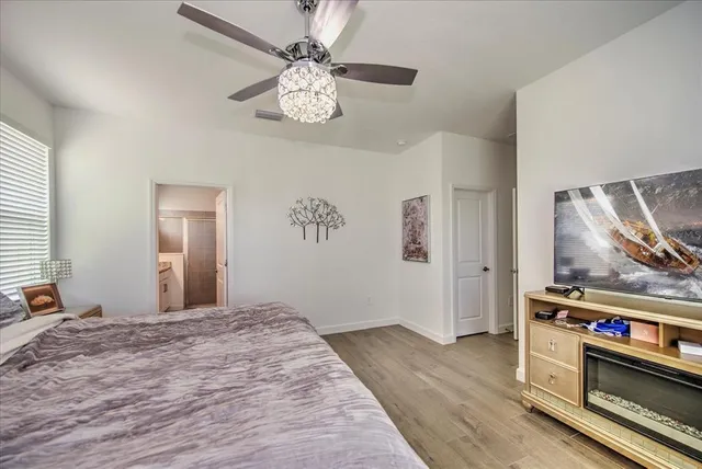 a bedroom with a bed and a chandelier