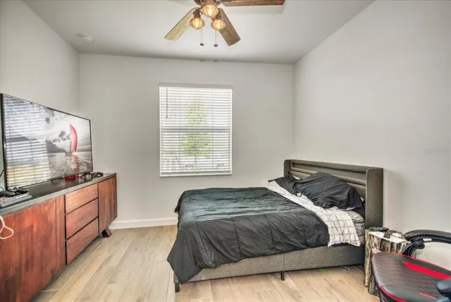 a bedroom with a bed and a flat screen tv