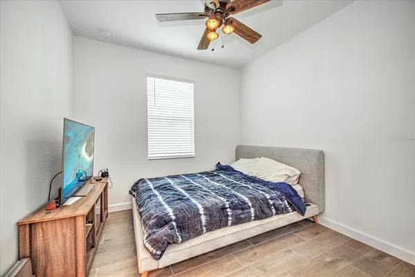 a bedroom with a bed and a chandelier