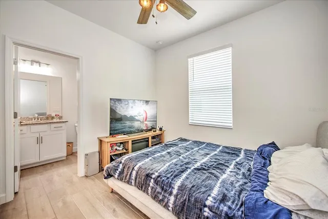 a bedroom with a bed and a flat screen tv