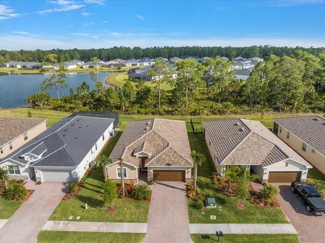 an aerial view of residential houses with outdoor space and river