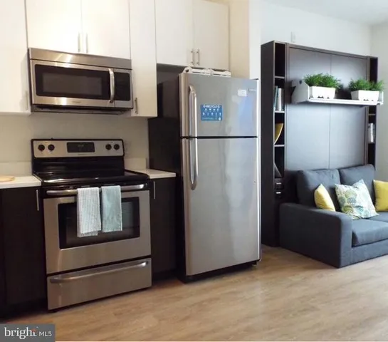 a kitchen with a refrigerator stove and microwave