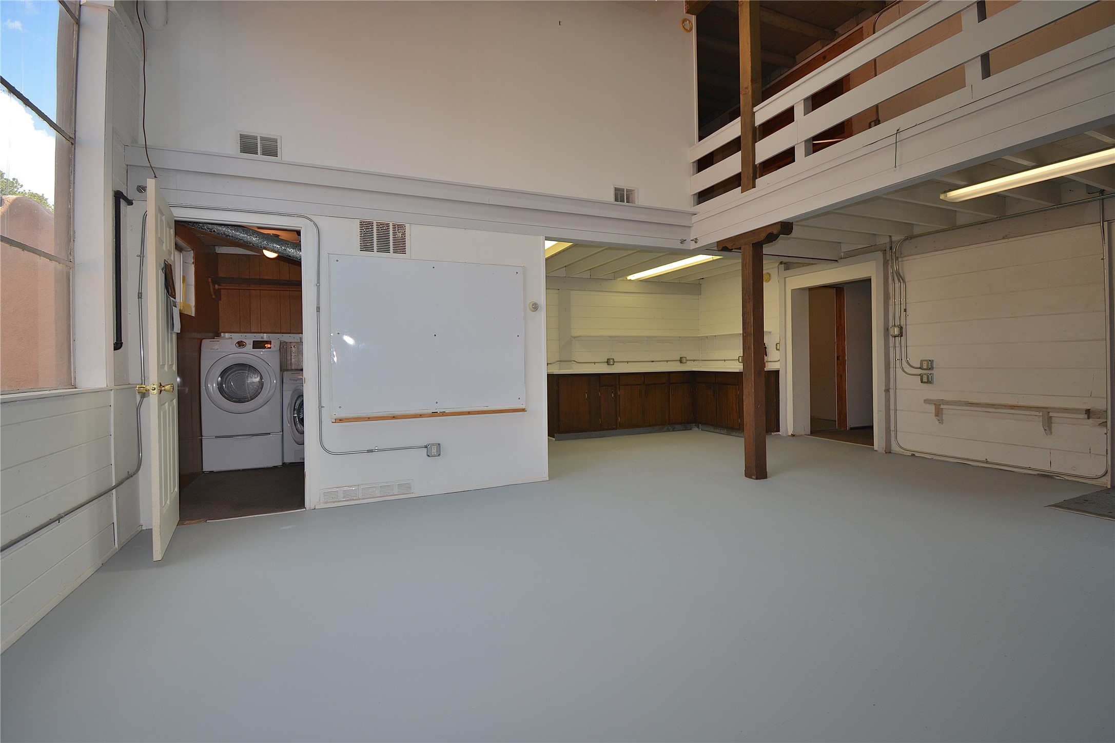 904 Bishops Lodge Road Santa Fe, NM 87501 - Photo 23 of 51 Downstairs studio with view to laundry and exit to garage