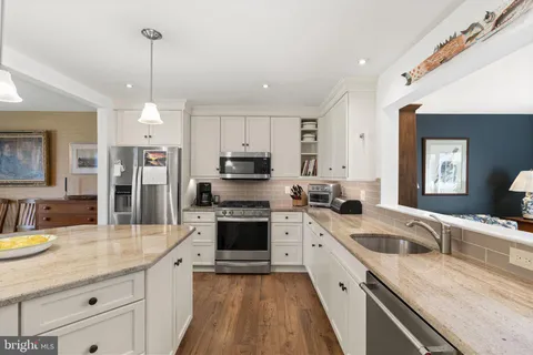 a kitchen with a sink stove and refrigerator