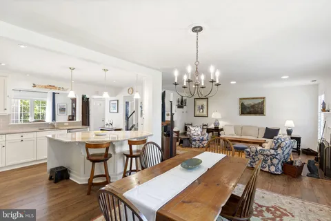 a living room with lots of furniture and a chandelier