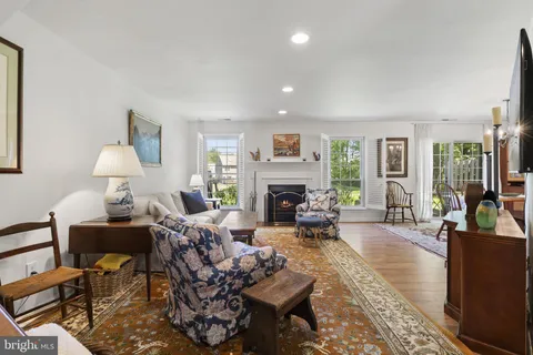 a living room with furniture fireplace and a table