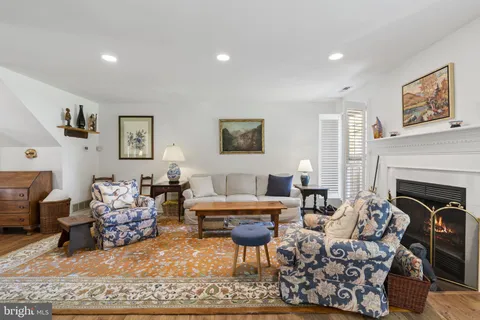 a living room with furniture large window and fireplace