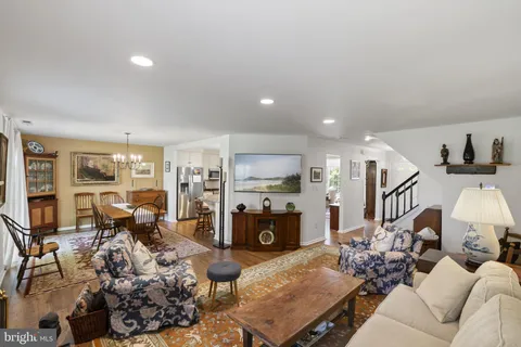 a living room with furniture fireplace and a view of kitchen