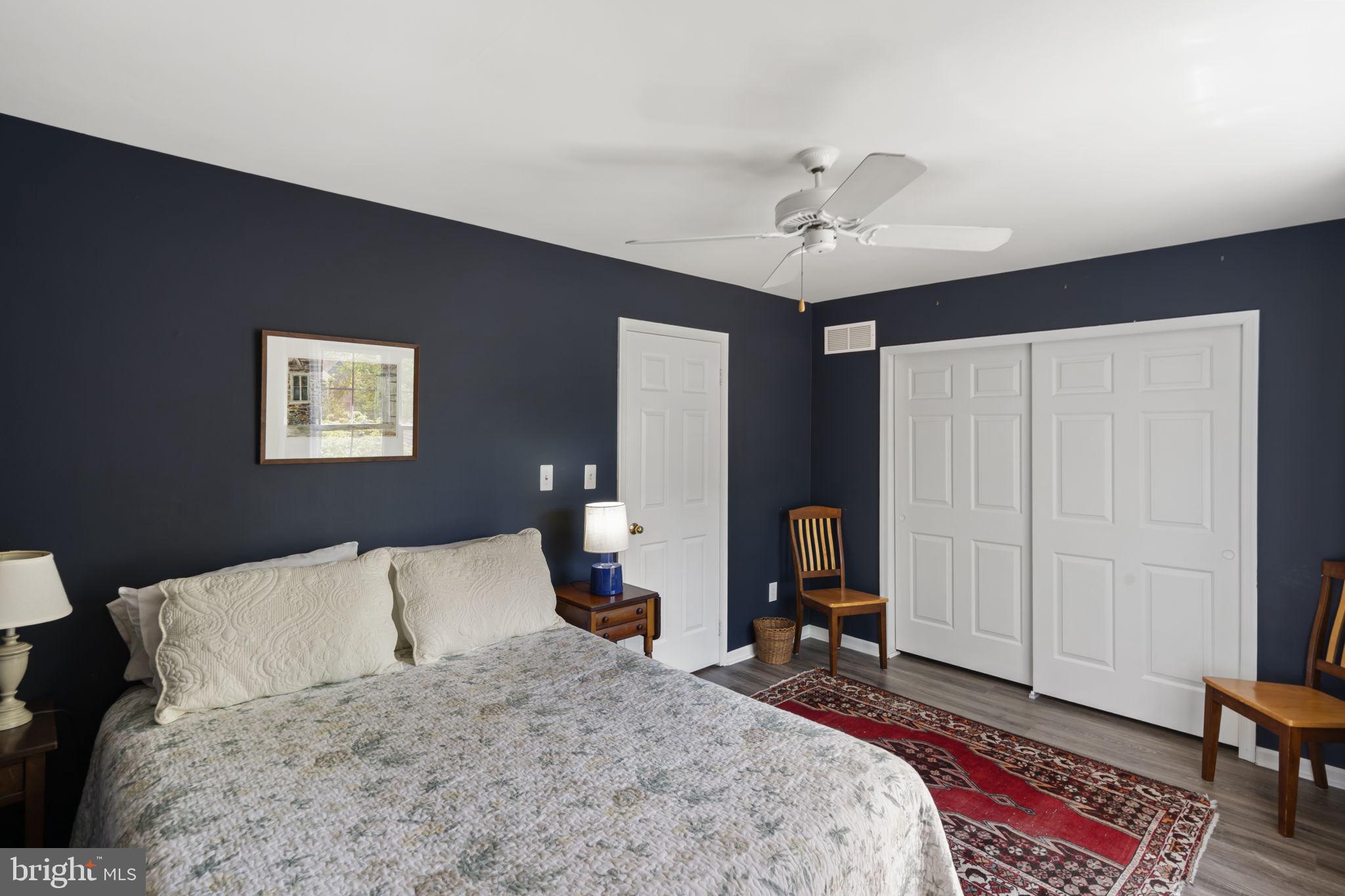 289 Tulip Tree Court Blue Bell, PA 19422 - Photo 31 of 51 a bedroom with a bed and a chandelier