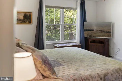 a bed sitting in a bedroom next to a window