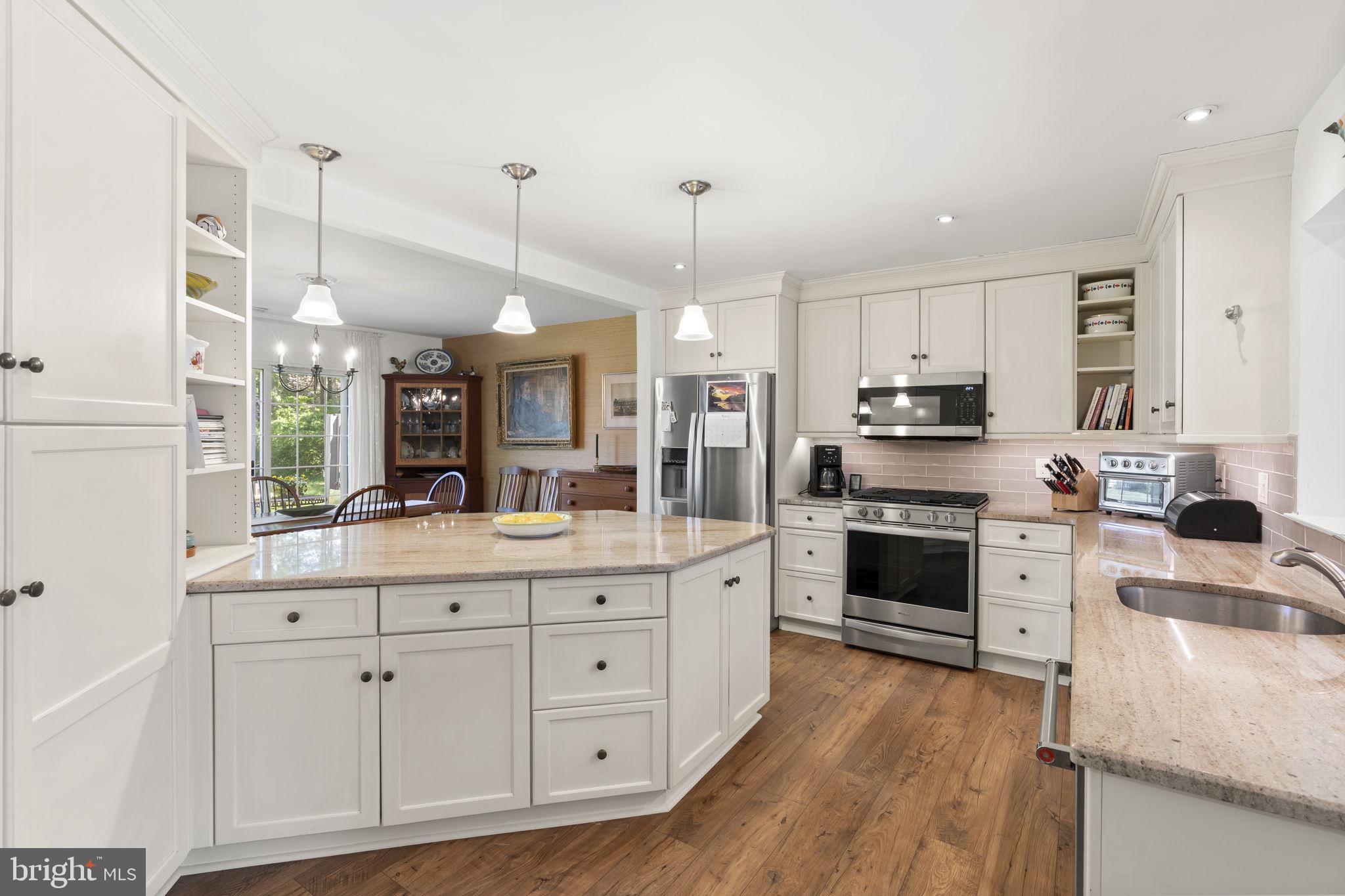 289 Tulip Tree Court Blue Bell, PA 19422 - Photo 4 of 51 a kitchen with white cabinets and stainless steel appliances