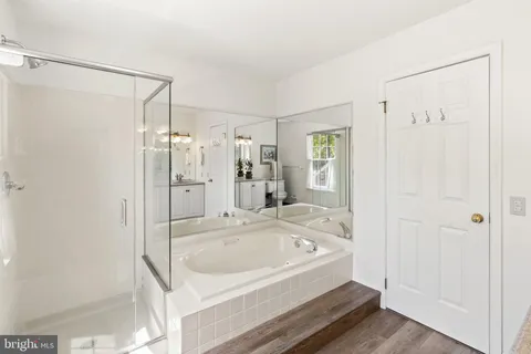 a bathroom with a bathtub and a shower
