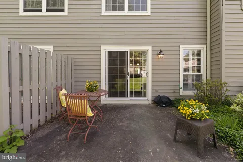 a wooden bench sitting in front of a house