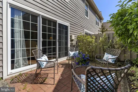 a building outdoor space with patio furniture and potted plants