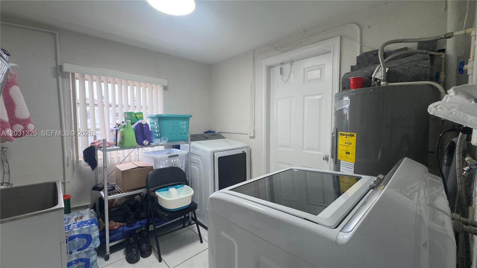 12480 Southwest 189th Street Miami, FL 33177 - Photo 18 of 25 a living room with furniture and a fireplace