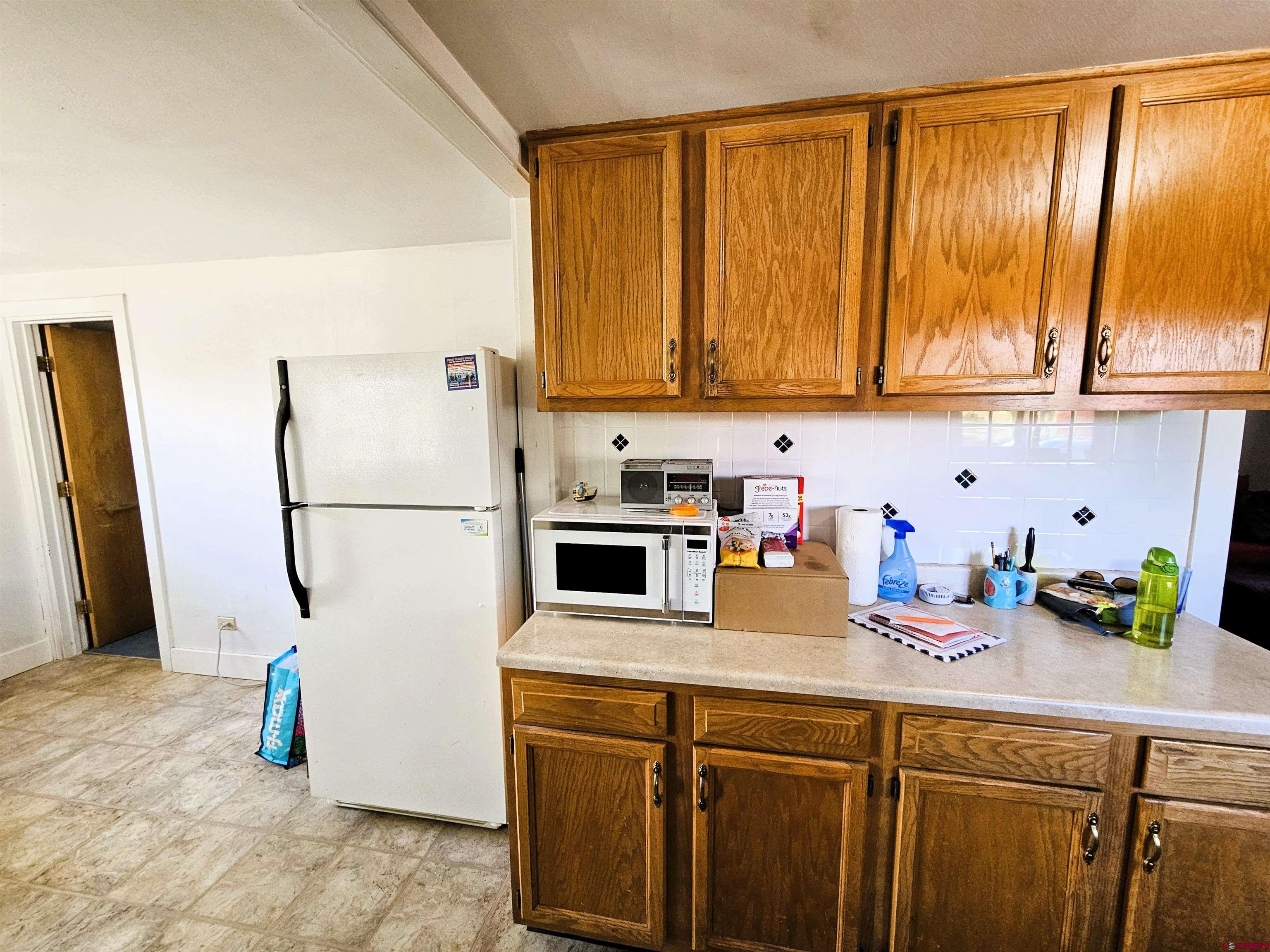 360 West 30th Street Durango, CO 81301 - Photo 12 of 30 a kitchen with a refrigerator and a sink