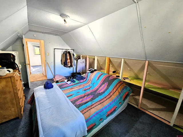 a room that has a bed and a dresser