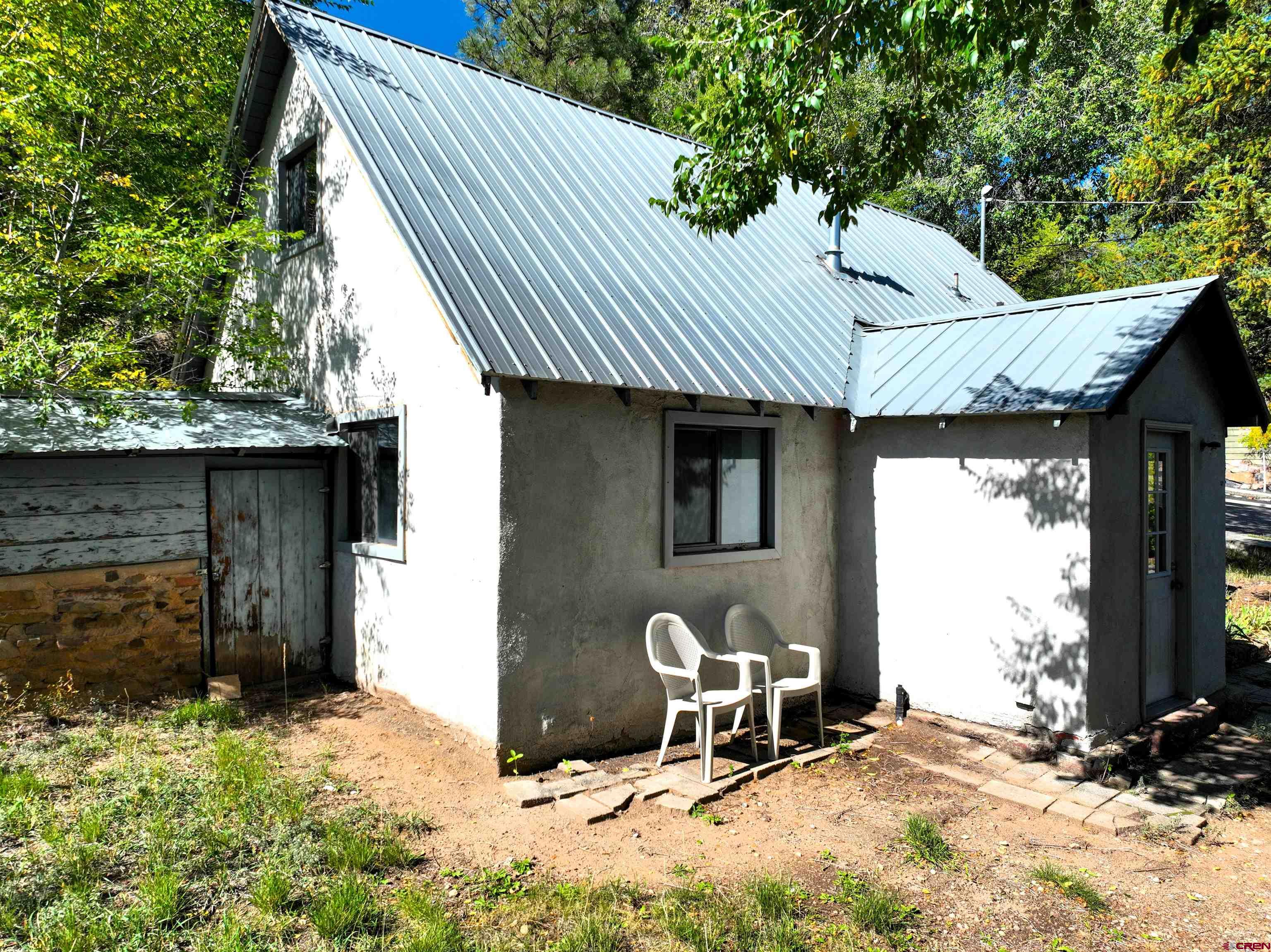 360 West 30th Street Durango, CO 81301 - Photo 7 of 30 a backyard of a house with table and chairs