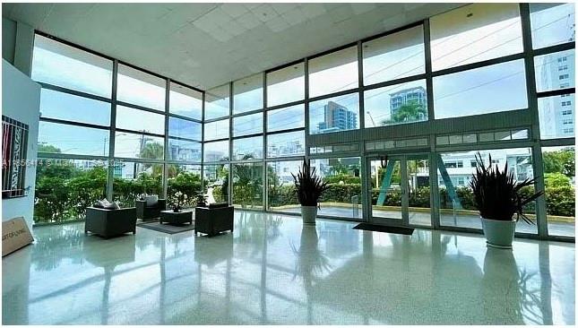a lobby with a potted plant on the floor