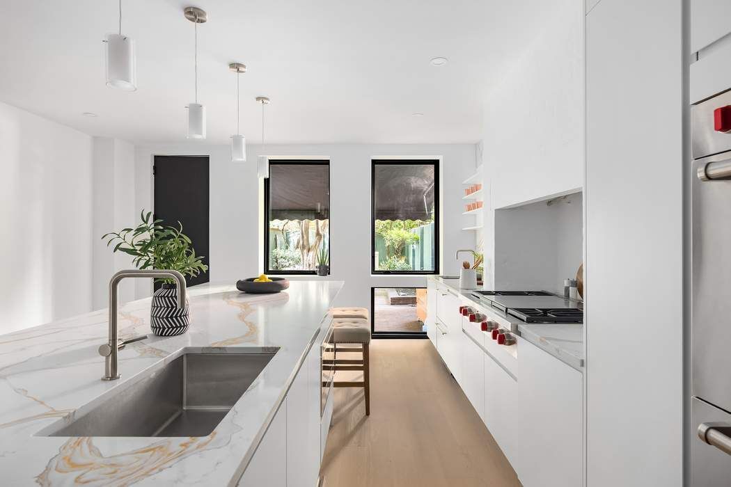 53 West 85th Street Manhattan, NY 10024 - Photo 11 of 37 a kitchen with granite countertop a stove and a sink
