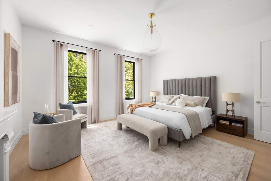 53 West 85th Street Manhattan, NY 10024 - Photo 16 of 37 a spacious bedroom with a bed and a couch