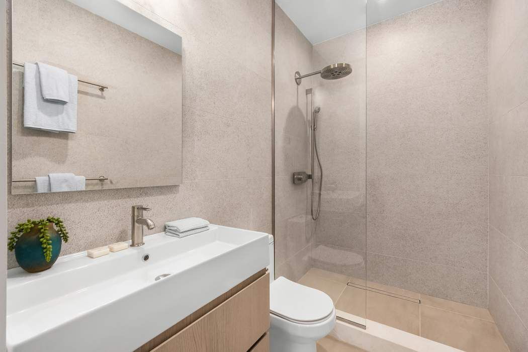 53 West 85th Street Manhattan, NY 10024 - Photo 30 of 37 a bathroom with a sink toilet and shower