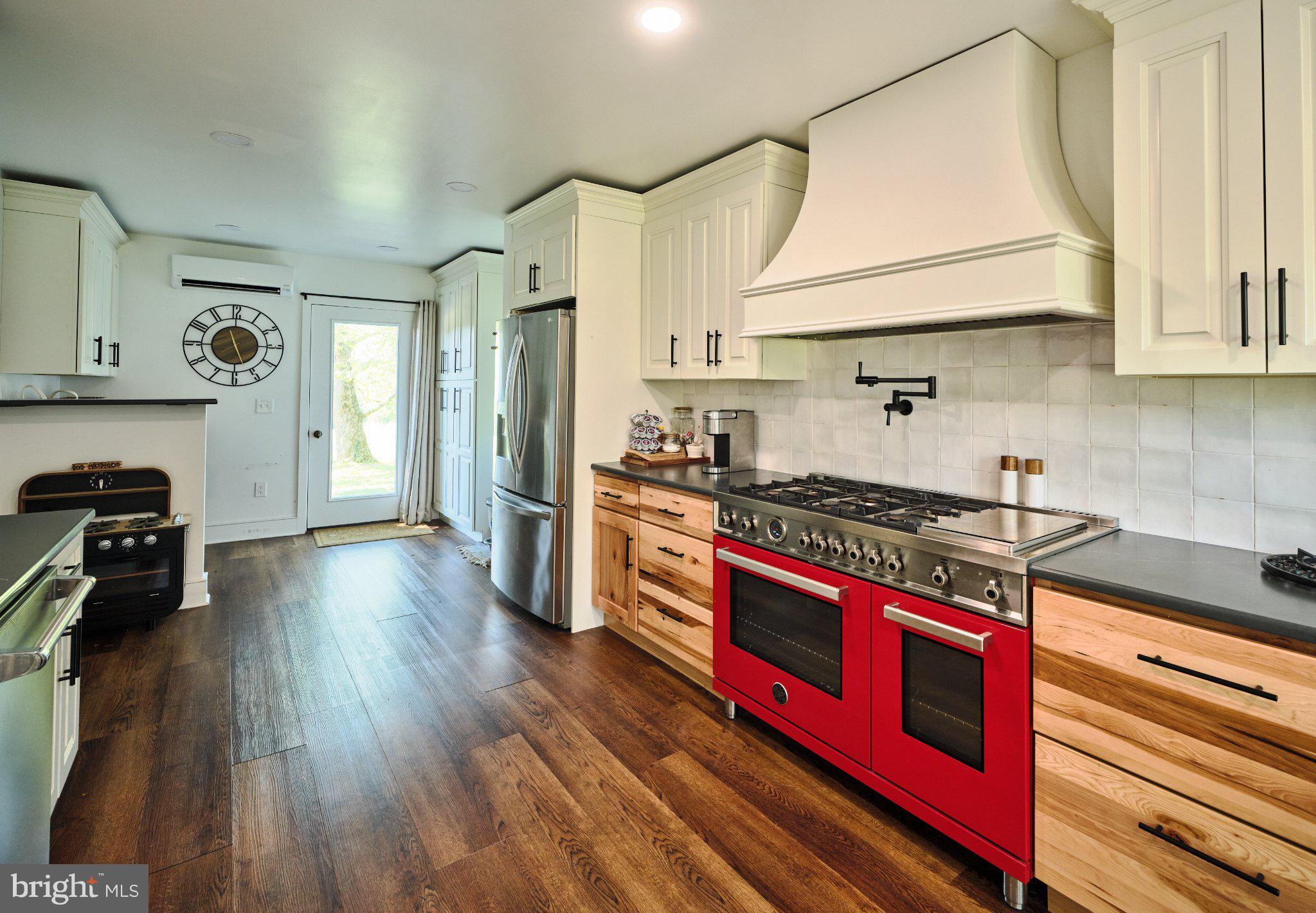 765 Swamp Road Newtown, PA 18940 - Photo 12 of 37 a kitchen with stainless steel appliances a stove a sink and a refrigerator