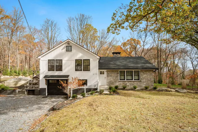 a front view of a house with a yard covered in snow