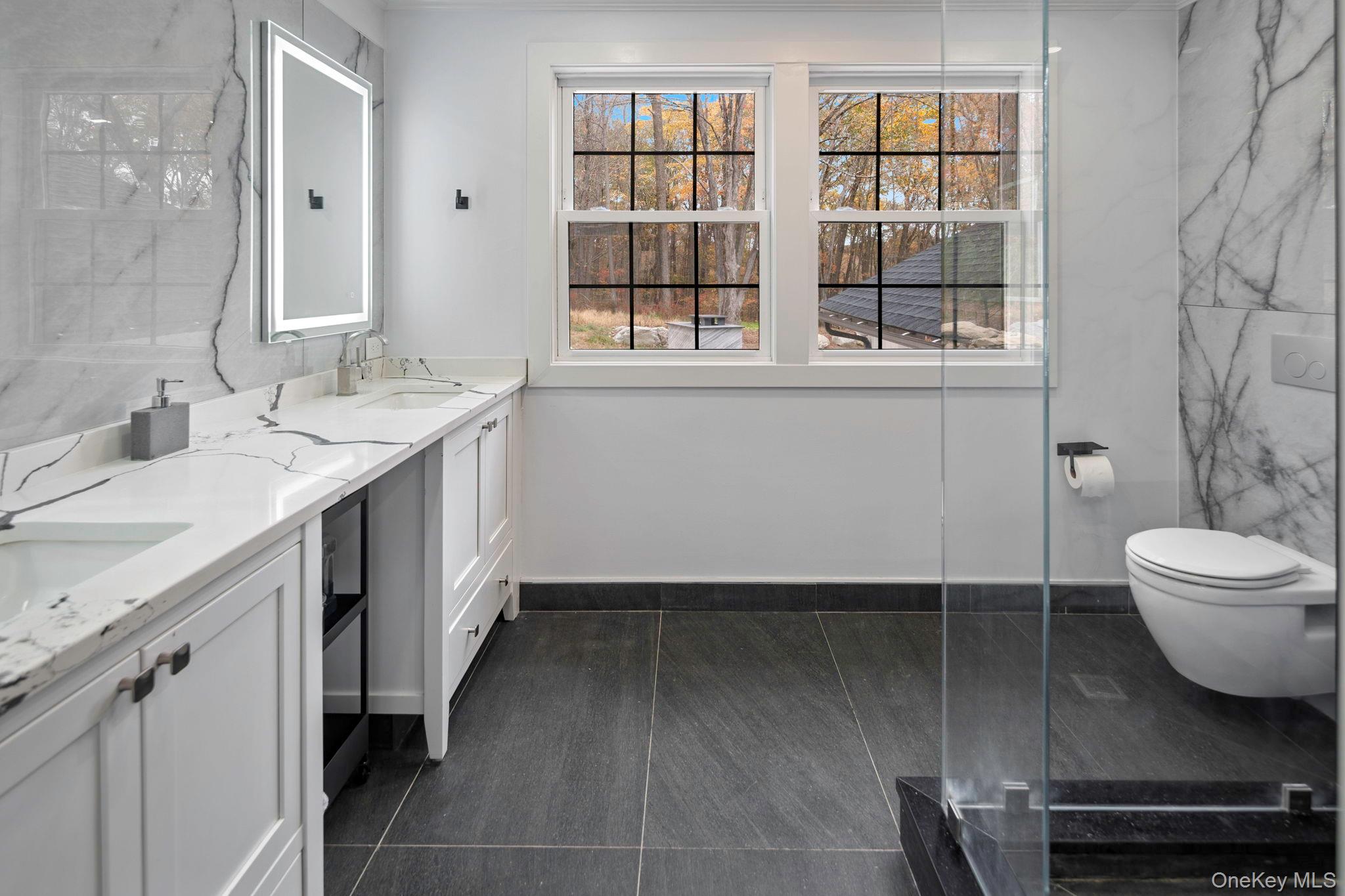 379 South White Rock Road Holmes, NY 12531 - Photo 11 of 26 Primary bath featuring double vanity, heated flooring, granite wall slabs