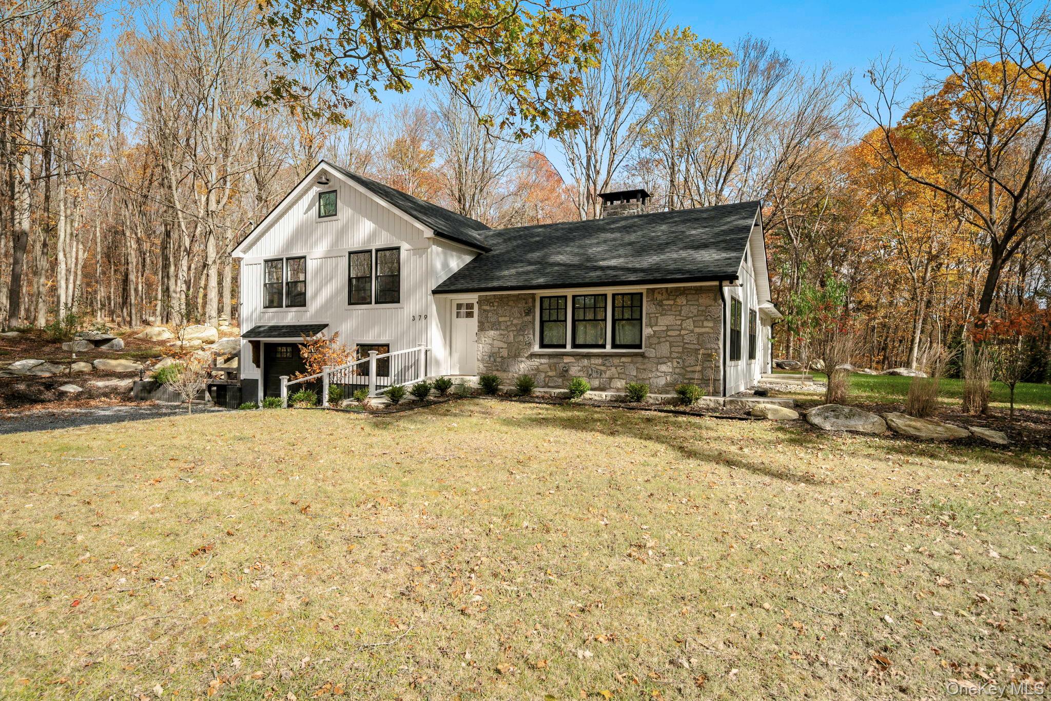 379 South White Rock Road Holmes, NY 12531 - Photo 22 of 26 View of front facade with stone siding, a front lawn, and a shingled roof