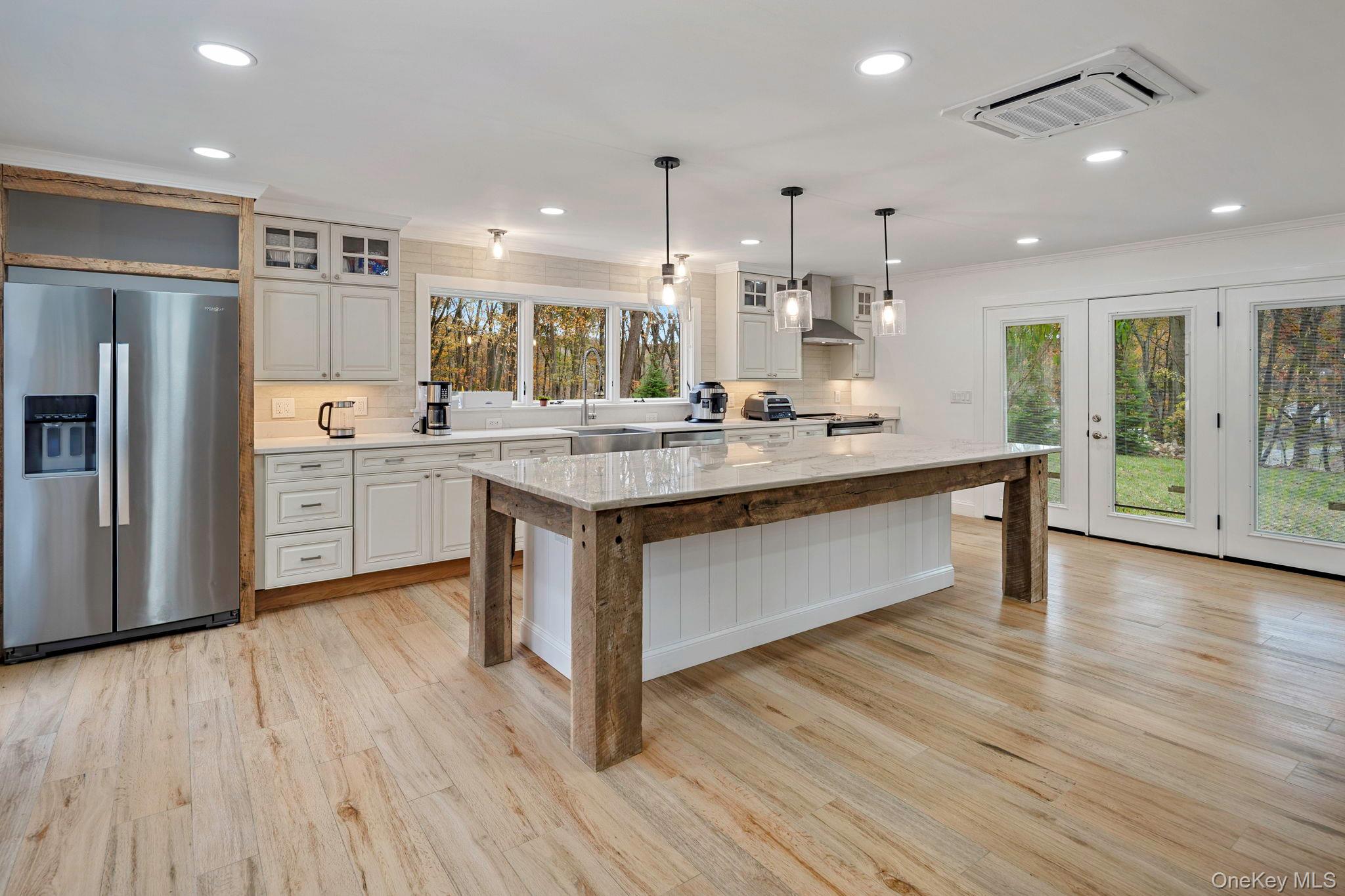 379 South White Rock Road Holmes, NY 12531 - Photo 5 of 26 Kitchen featuring decorative backsplash, glass insert cabinets, stainless steel fridge with ice dispenser, a center island, and recessed lighting