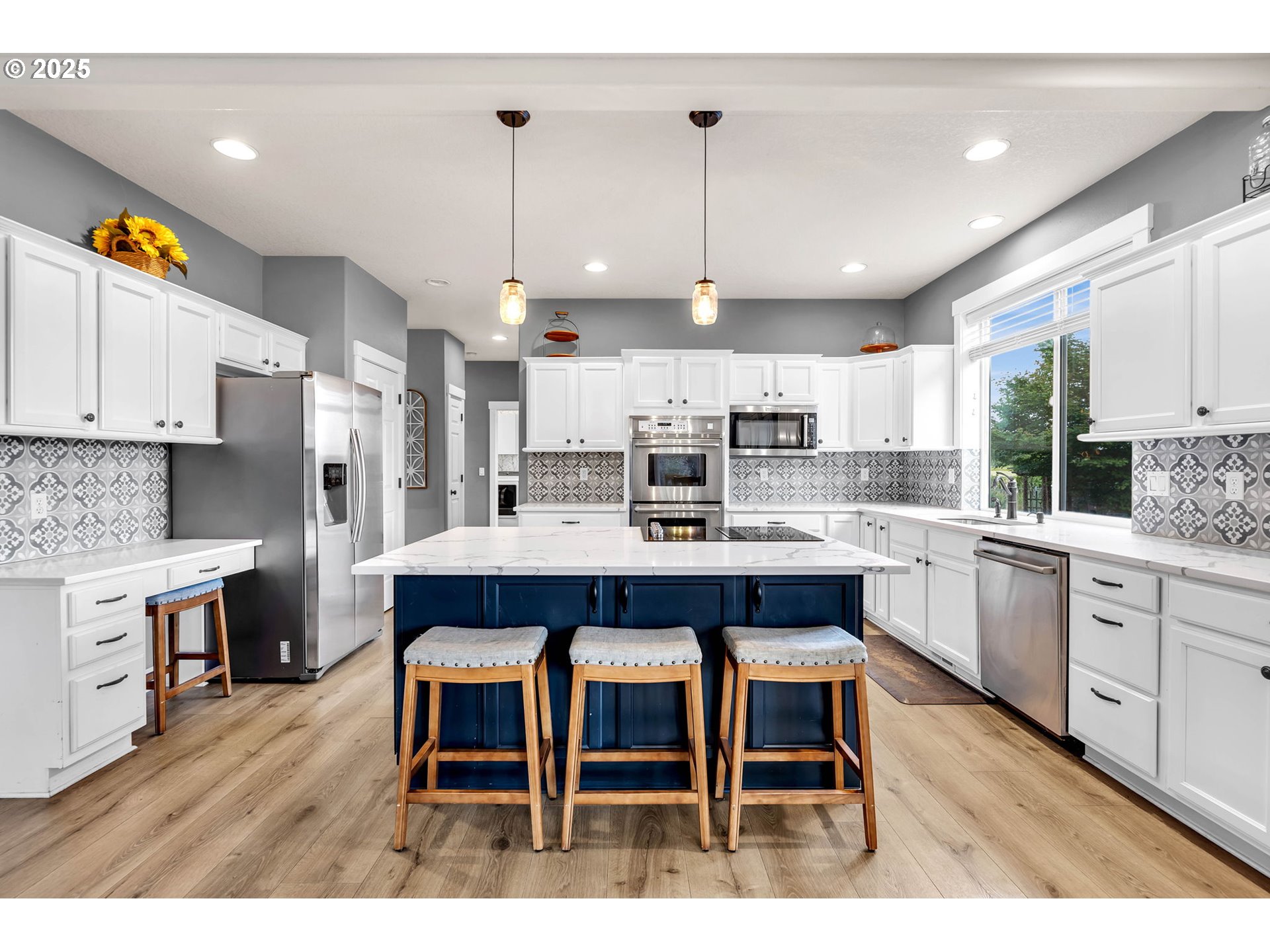 8805 Northeast 179th Street Battle Ground, WA 98604 - Photo 12 of 48 a room with stainless steel appliances kitchen island granite countertop a dining table chairs sink and cabinets