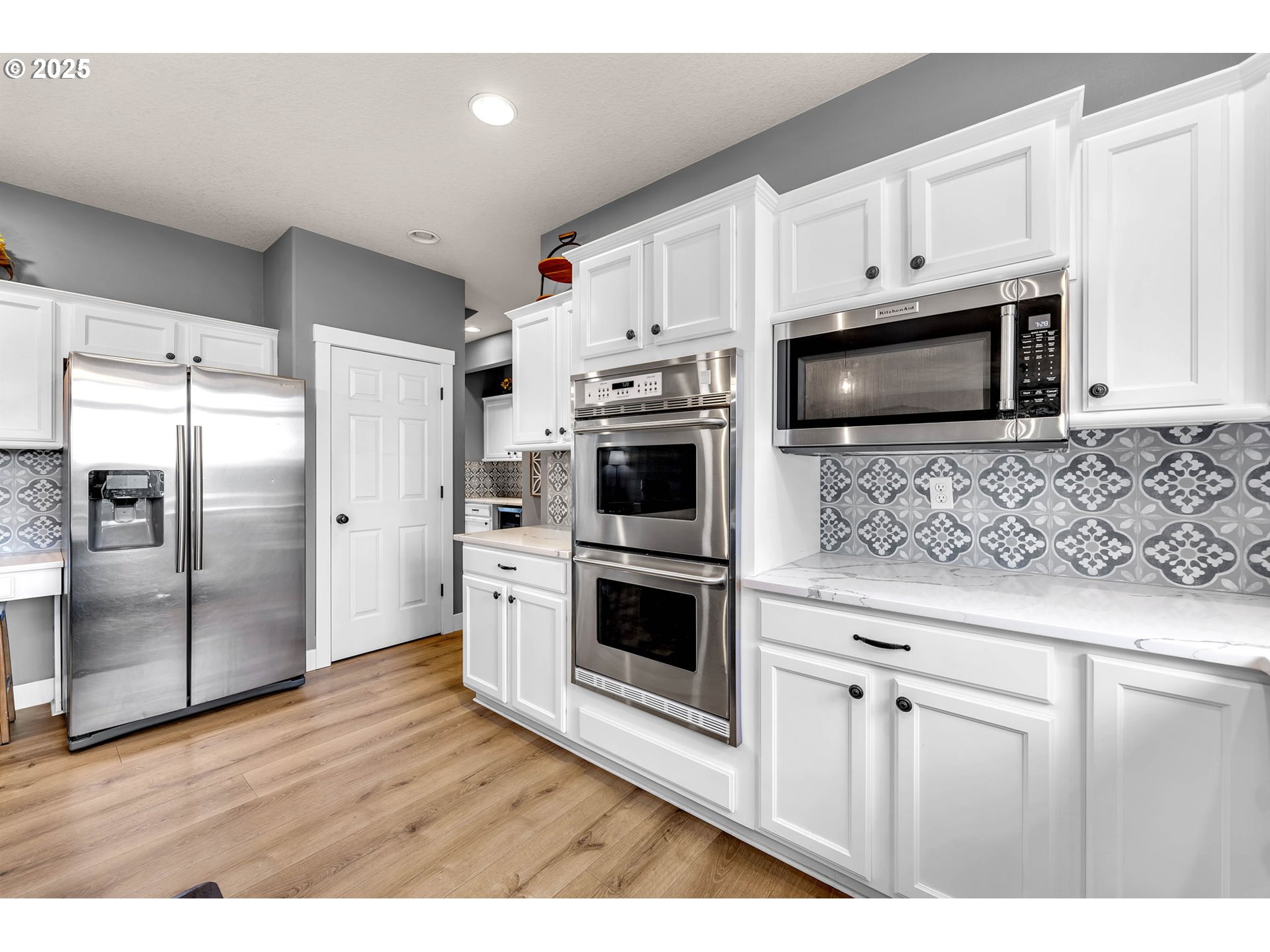 8805 Northeast 179th Street Battle Ground, WA 98604 - Photo 14 of 48 a kitchen with stainless steel appliances white cabinets a sink and a oven